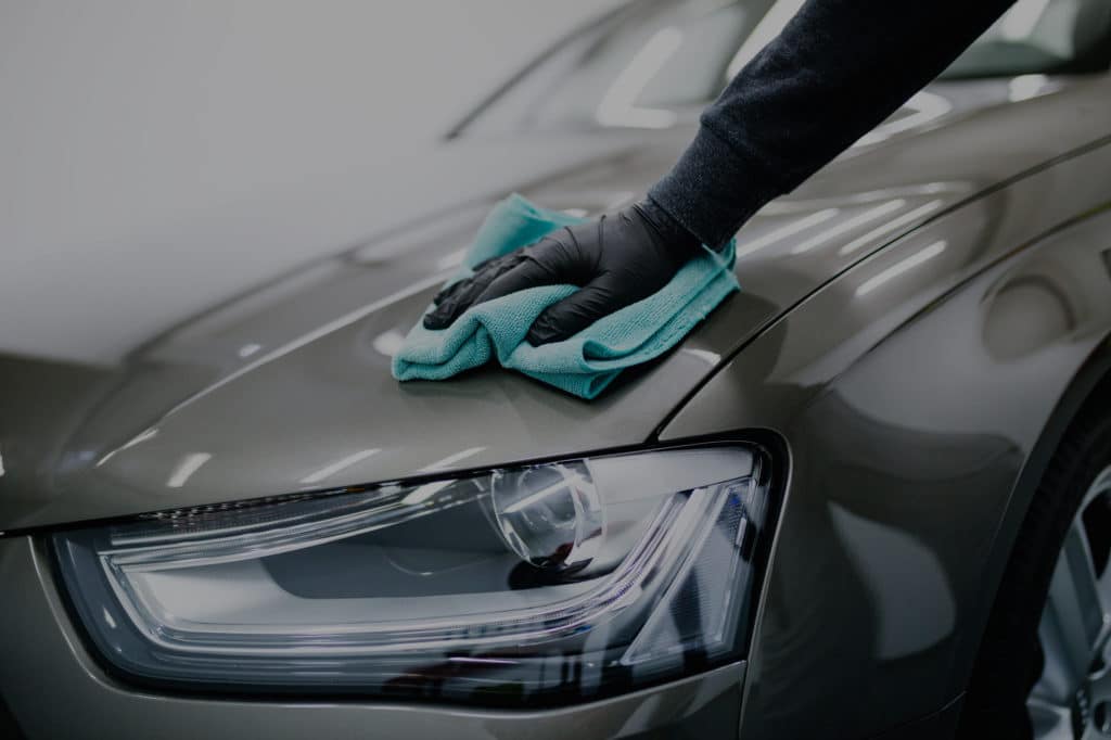 Our experienced detailer cleaning car with microfiber cloth